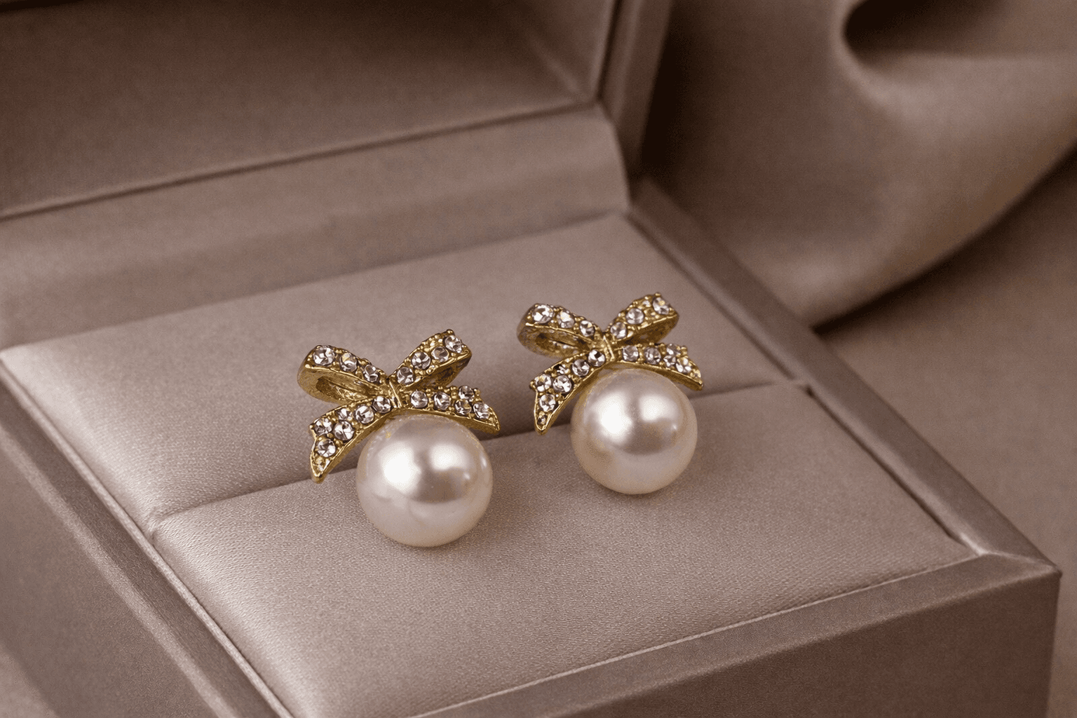 Gold Toned Bow Pearl Stud Earrings with American Diamonds