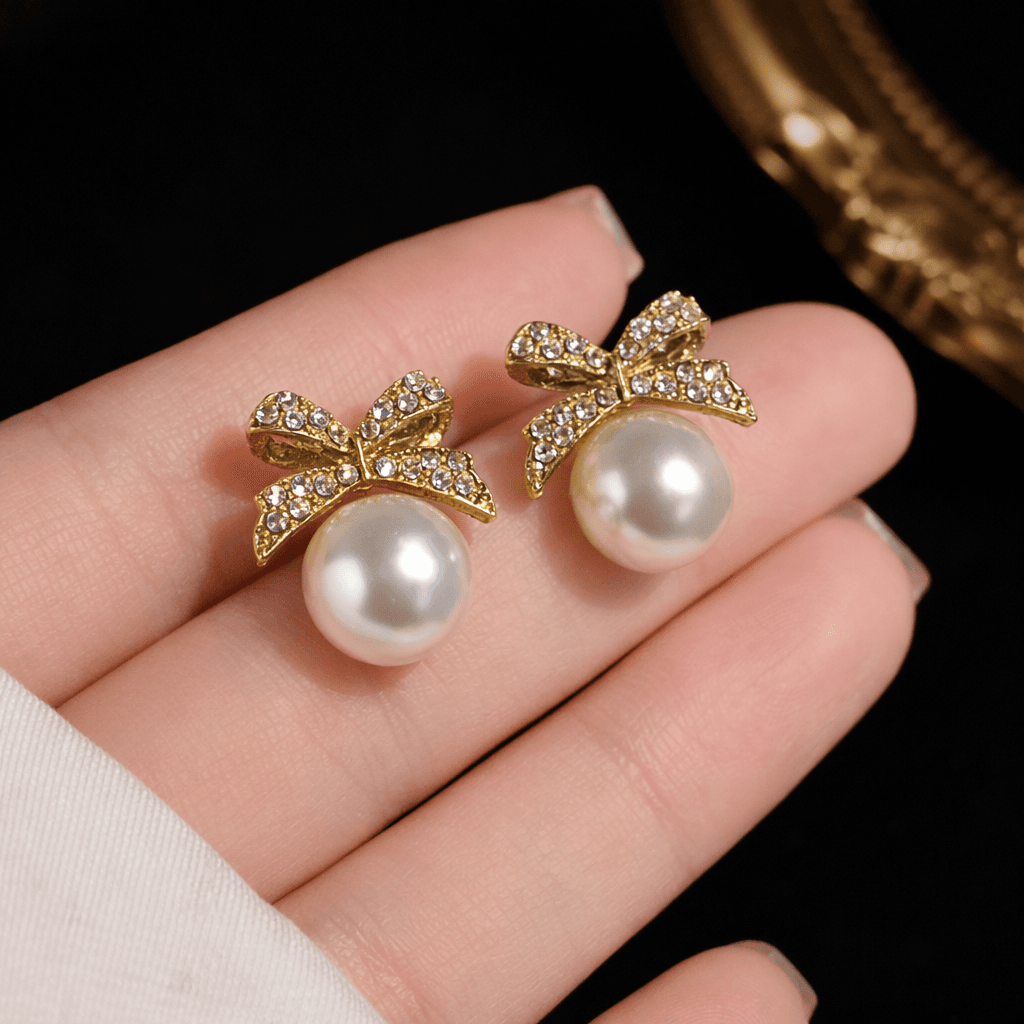 Gold Toned Bow Pearl Stud Earrings with American Diamonds